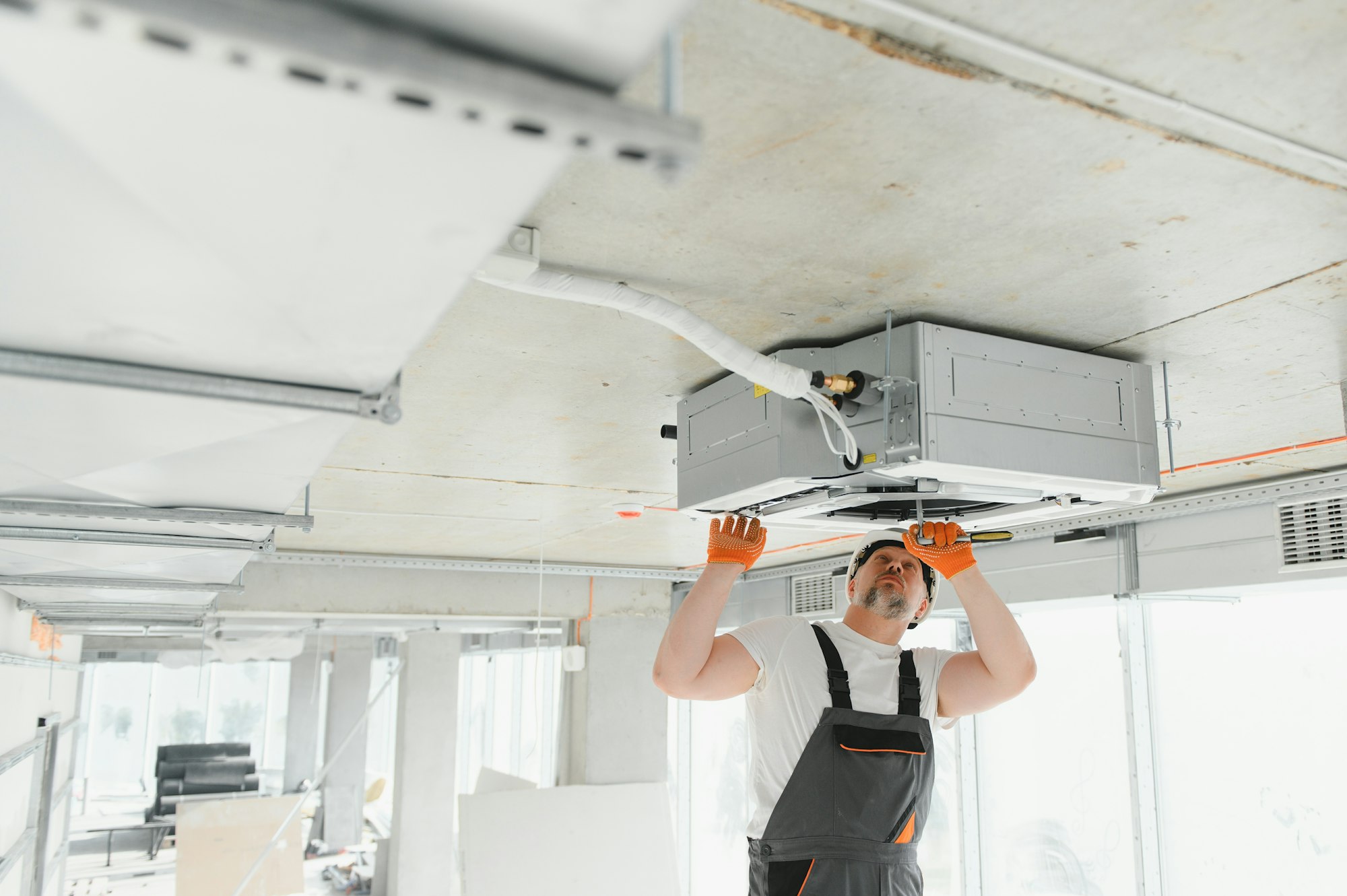 male-technician-installing-of-air-conditioner